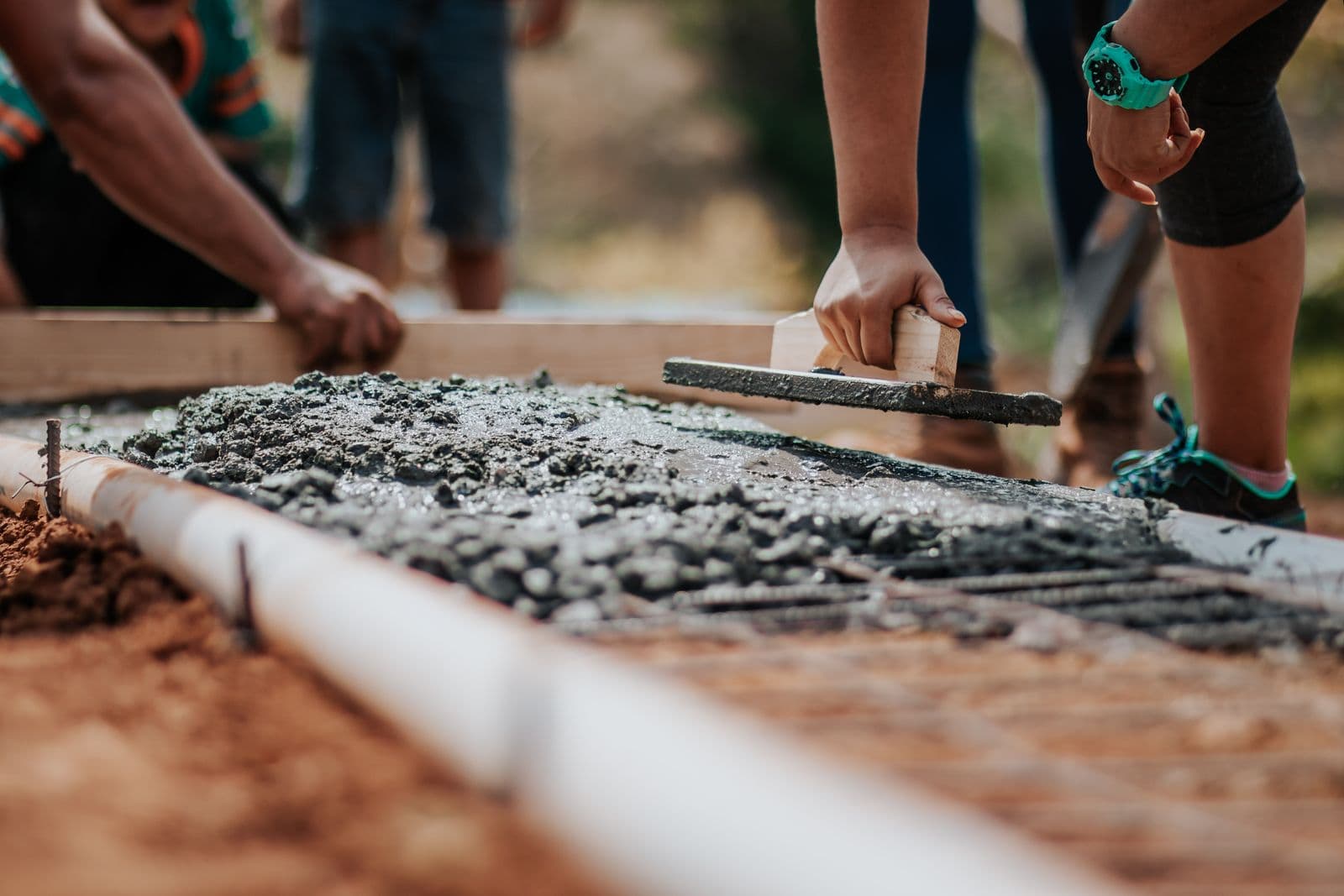 Crew finishing a concrete pour on a job site